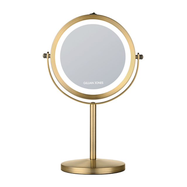 Espejo de maquillaje redondo dorado con luz LED, vista frontal con logo Gillian Jones