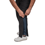 Primer plano de manos desabrochando pantalones térmicos Dobsom por el lado sobre vaqueros